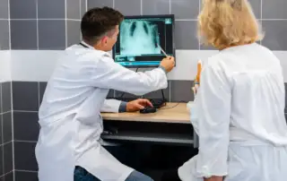 médicos discutindo um exame para telerradiologia em emergências